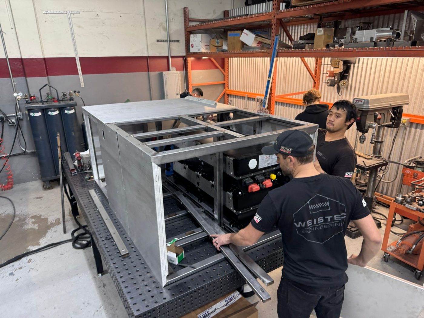 The team fitting the TAP enclosure frame on the fixture table