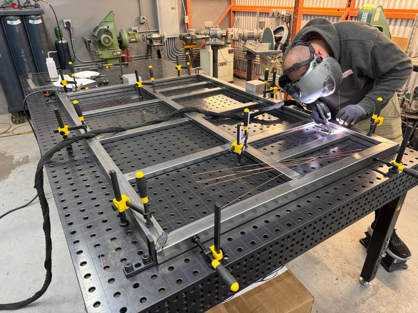 TIG welding the TAP frame on a fixture table