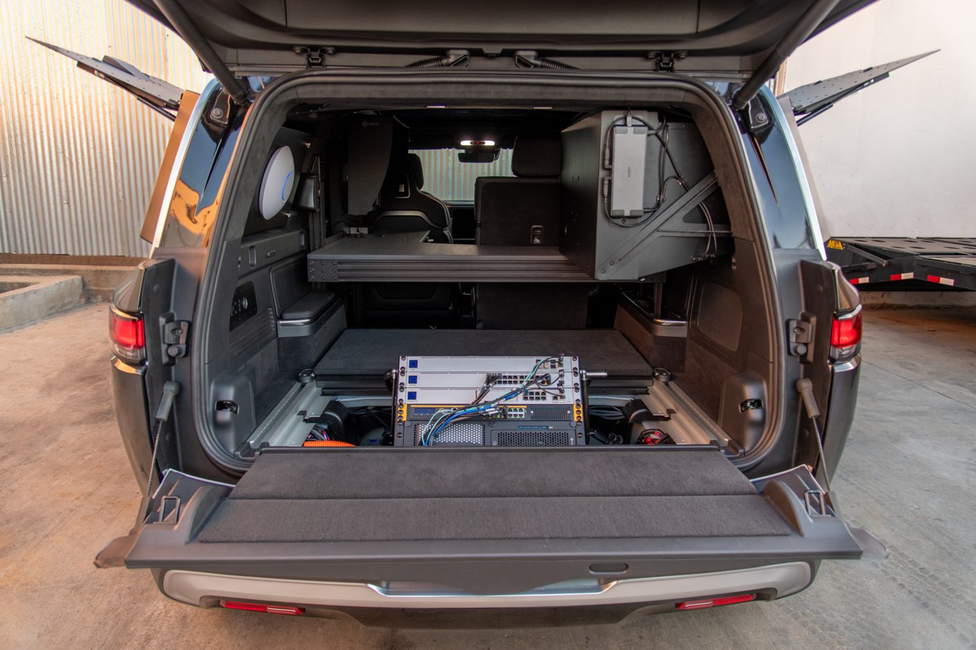 Custom rear cargo build-out with slide-out storage in the Rivian R1S