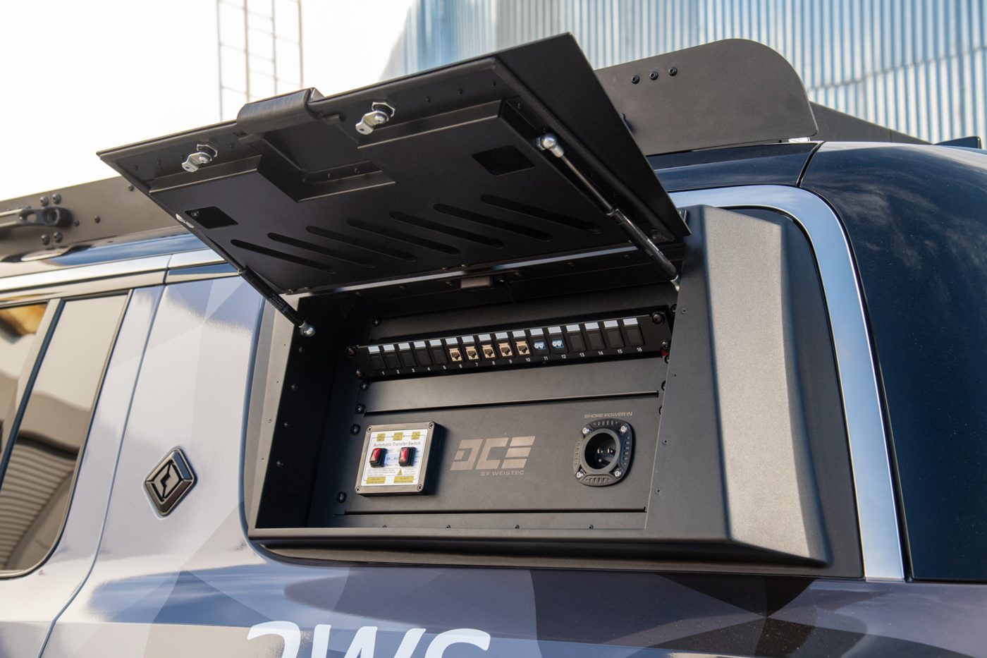 Open side storage box on the Rivian R1S with DCE power panel
