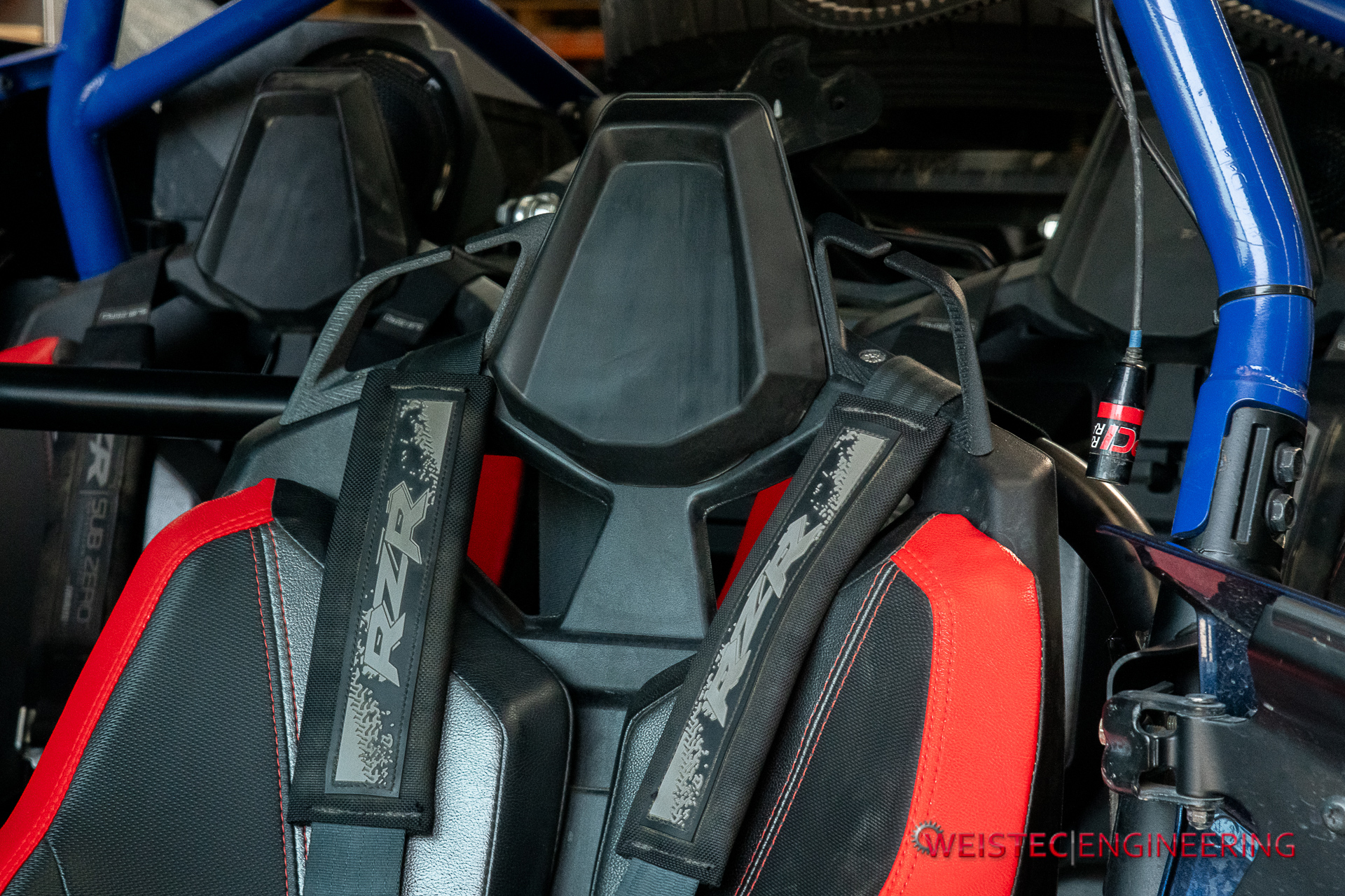 harness strap guide installed on a RZR Pro R seat