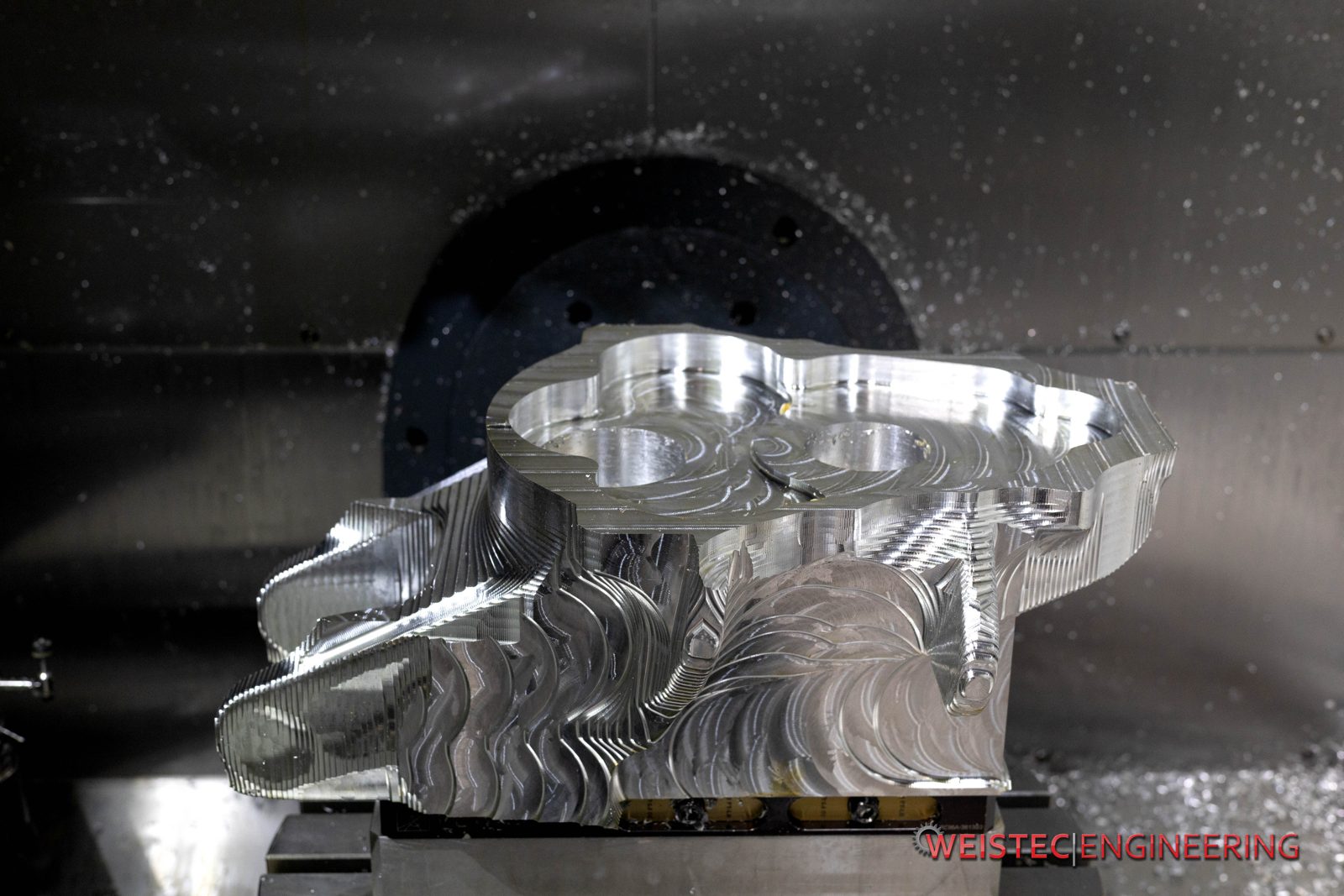 7075 aluminum billet mid-machining with contoured toolpaths