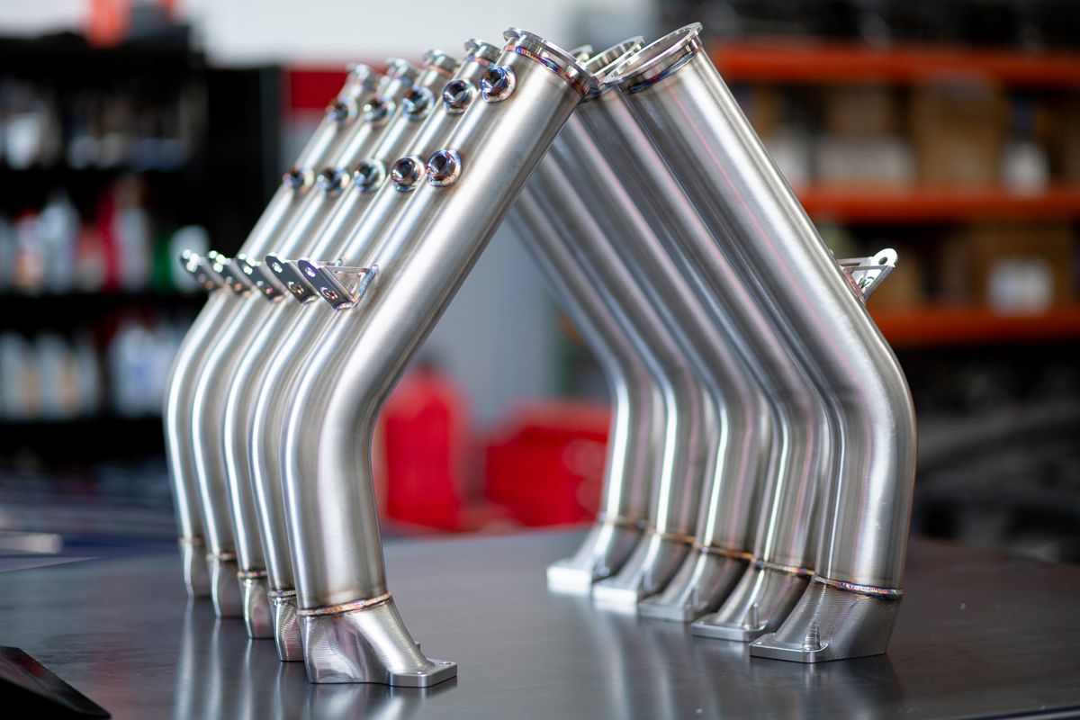 Row of mandrel-bent stainless steel tube assemblies