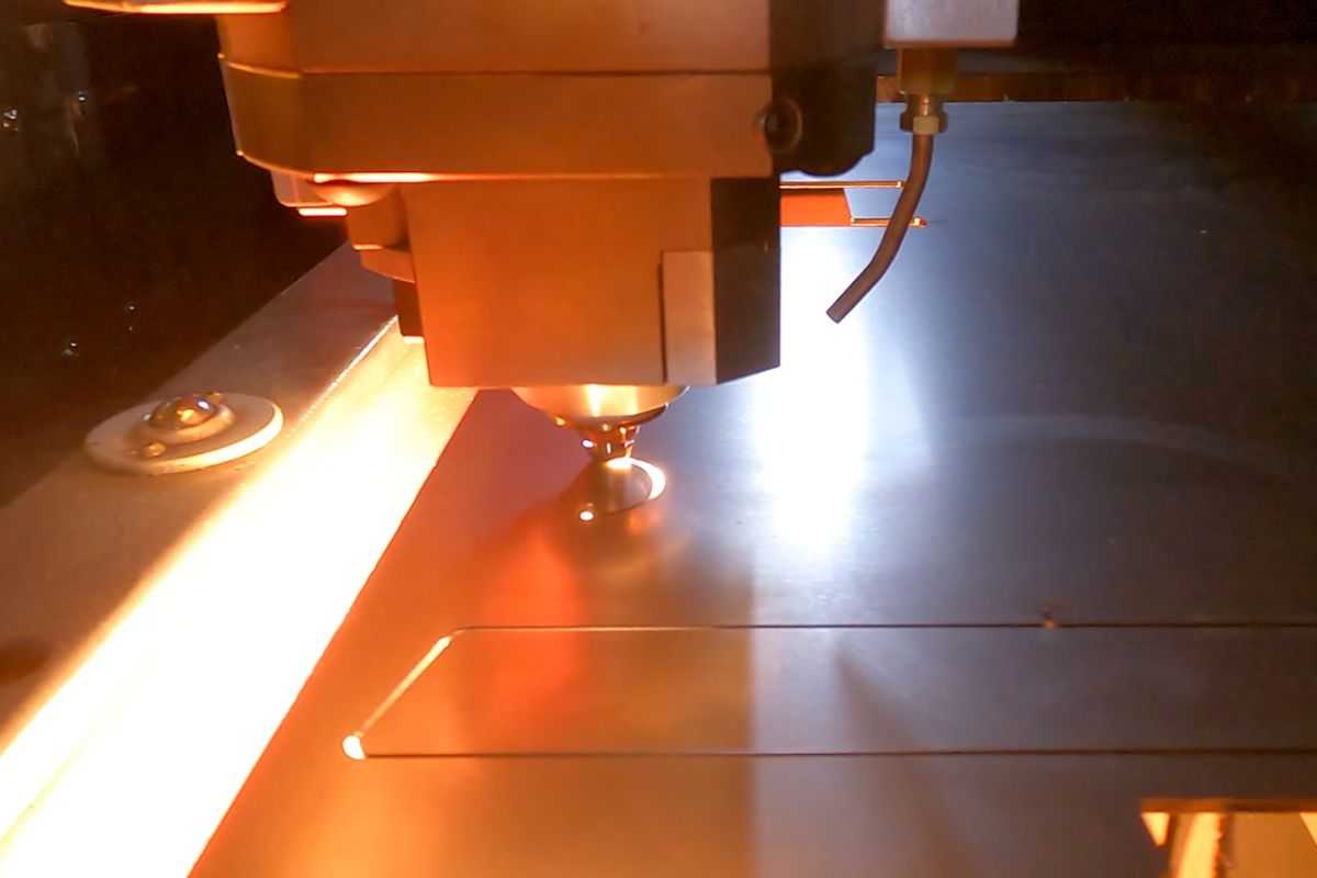 Fiber laser cutting head over sheet metal
