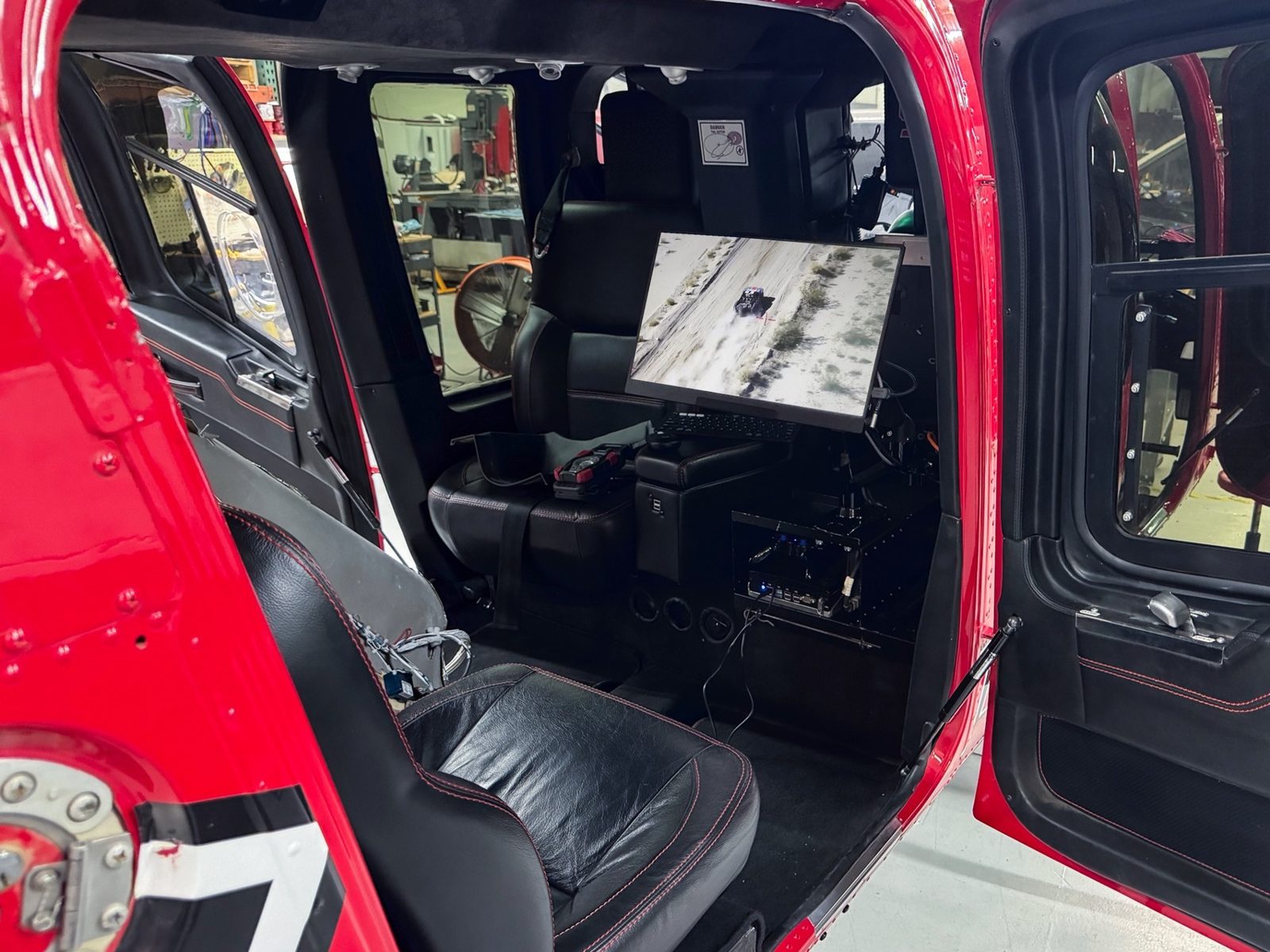 Helicopter cabin equipment install showing the live gimbal camera feed on the mounted display, built by Weistec