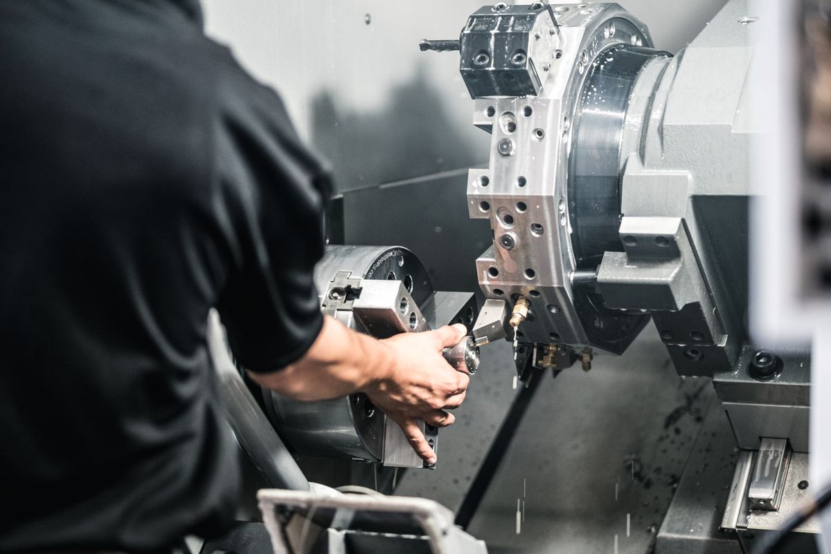 Machinist loading a part into a Haas mill-turn lathe