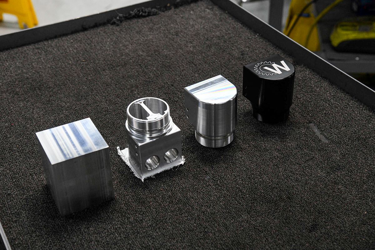 Raw aluminum stock, machined prototype and finished anodized production part