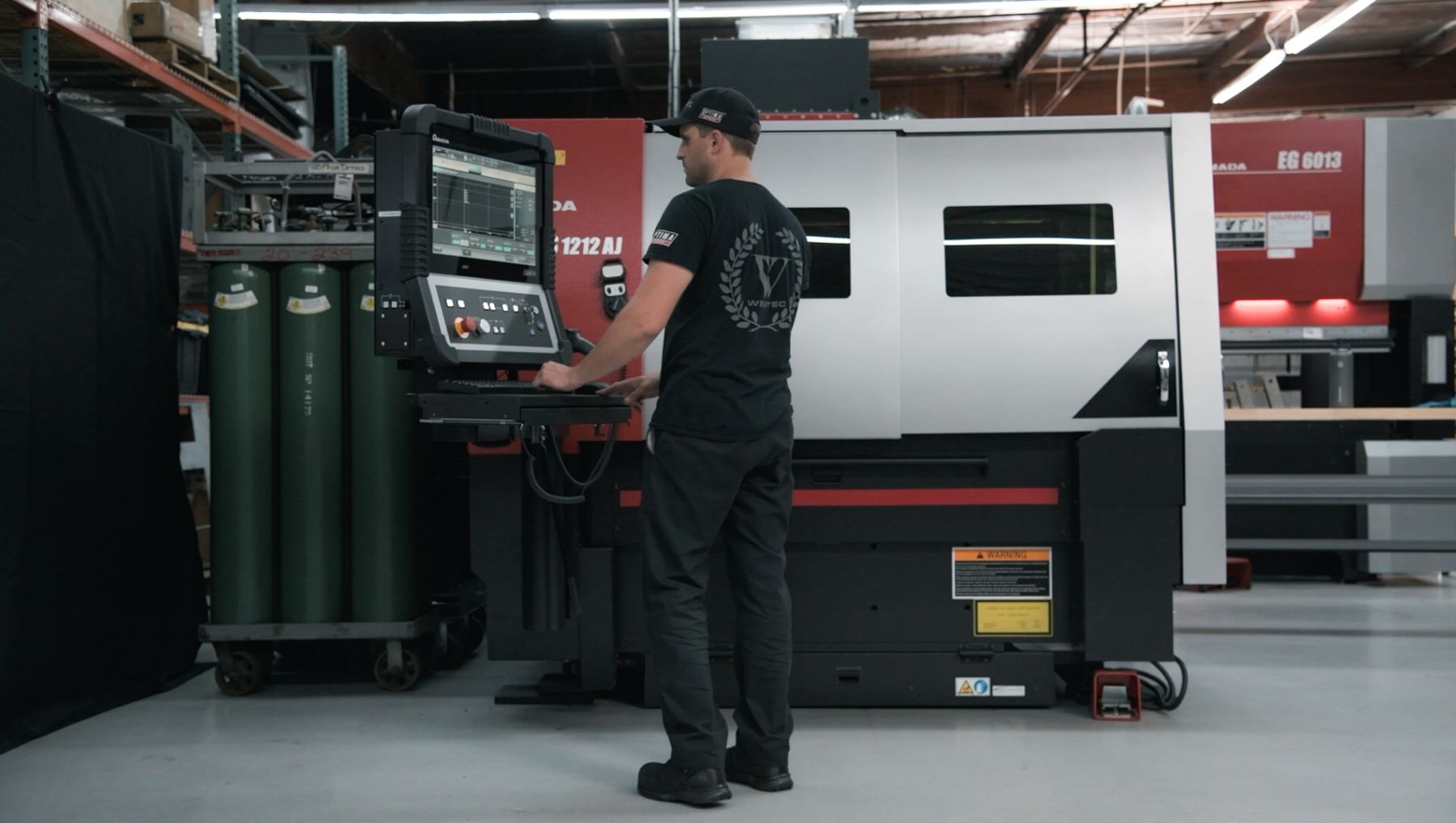 Weistec team member running the fiber laser in our Anaheim shop