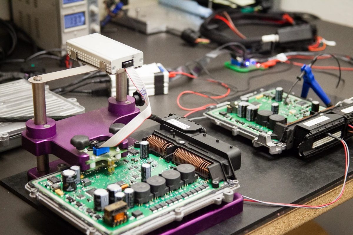 Engine control units on the bench with a read/write fixture during calibration development